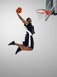 Fotografia Basketball player dunking ball low angle view, Blake Little