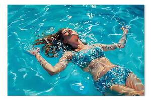 Quadro su tela Spensieratezza alla deriva - donna in costume blu che galleggia
