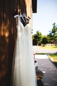 Fotografia artistica Beautiful white wedding dress hanging elegantly, Wirestock, (26.7 x 40 cm)
