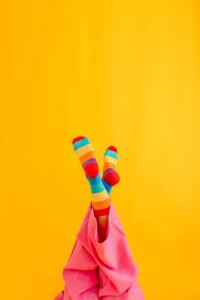 Fotografia artistica Woman wearing colorful socks against yellow, Westend61, (26.7 x 40 cm)