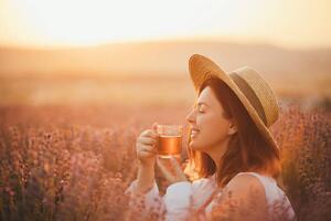 Fotografia Young happy woman drinking herbal tea, Polina Lebed, (40 x 26.7 cm)