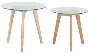 Set di 2 tavolini a nido tondi trasparenti con piano in vetro 3 gambe in legno chiaro minimalista scandinavo Beliani