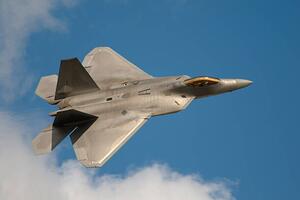 Fotografia F22 Raptor Jet Fighter flying in the sky, JohnnyPowell