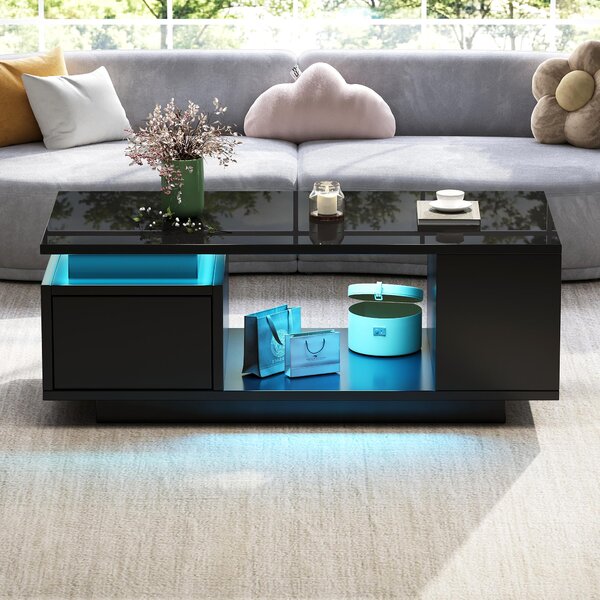 Tavolino da divano, dimensioni 100 x 50 x 36 cm, realizzato in pannello di particelle al 100%, colore nero, con 1 cassetto, 4 vani portaoggetti laterali e illuminazione a LED