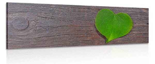 Stampa su tela – Foglia a forma di cuore su sfondo di legno
