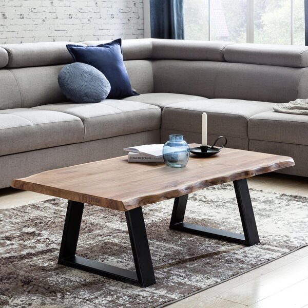 Tavolino FineBuy in legno massello di acacia, 115 cm. Tavolino rettangolare da salotto con bordo naturale e piedini in metallo nero. Tavolino di design realizzato a mano