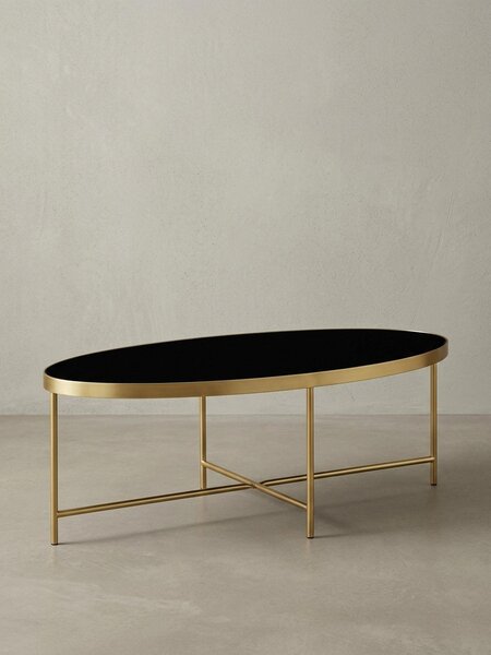 Tavolino "Vils", ovale, piano in vetro, struttura in metallo filigranato, nero/oro. 110x56x40 cm | Kadima Design
