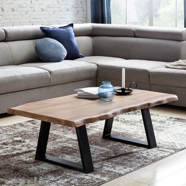Tavolino FineBuy in legno massello di acacia, 115 cm. Tavolino rettangolare da salotto con bordo naturale e piedini in metallo nero. Tavolino di design realizzato a mano