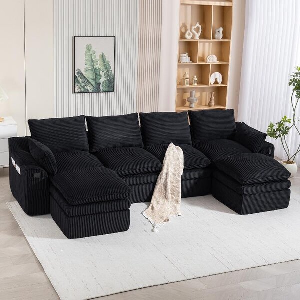 Divano modulare a 4 posti, rivestito in tessuto nero, dimensioni 335x167x85 cm, completo di 2 poggiapiedi, cuscini, tasche laterali e imbottitura in schiuma a 3 strati con nucleo in molle