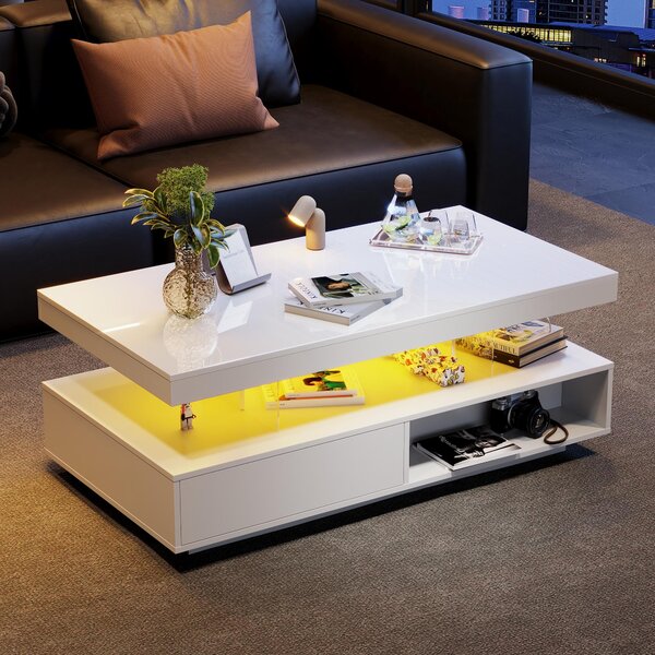 Tavolino bianco con piano lucido, dimensioni 95x50x42,5 cm, realizzato in pannello di particelle di legno e vetro, dotato di 2 cassetti e illuminazione LED per il soggiorno